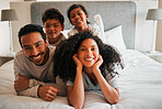 Portrait, morning and happy with family in bedroom for bonding, love and support. Wake up, trust and care with parents and children relax in bed at home for funny, excited and happiness together