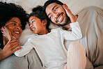 Top view, relax and family in a bedroom, smile and talking with weekend break, bonding and laughing together. Parents, mother and father with child, bed and funny with humor, home and relax with love