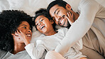 Top view, home and family with love, funny and bedroom with happiness, bonding and laughing together. Parents, mother and father with child, bed and kid with humor, joke and relax with weekend break