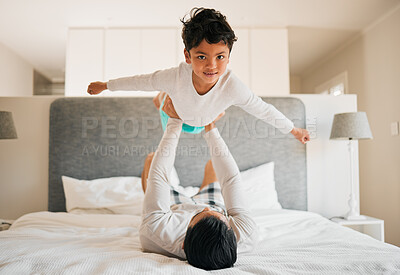 Buy stock photo Portrait, boy and father on bed for airplane games, support and relax for fun in morning together at home. Dad lifting happy kid to fly for freedom, fantasy and balance for play, trust and energy 