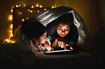 Night, tablet and mother with child in tent with fairy lights for bedtime story, movies and online cartoons. Happy family, bedroom and mom and kid on digital tech for bonding, love and care in home 