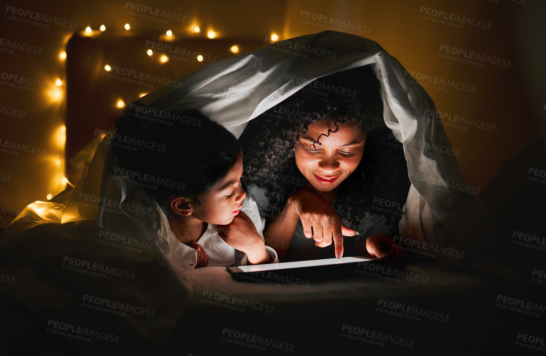 Buy stock photo Night, tablet and mother with child in tent with fairy lights for bedtime story, movies and online cartoons. Happy family, bedroom and mom and kid on digital tech for bonding, love and care in home 