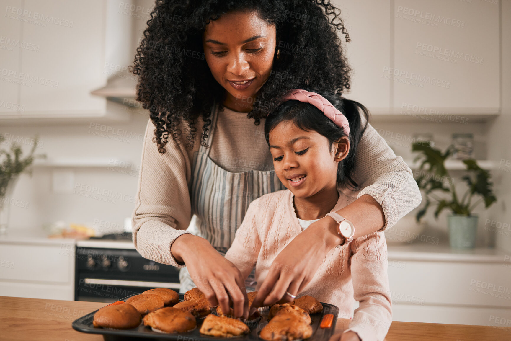 Buy stock photo Kitchen, mom and kid, cupcake eating in house and baking  together, happy with dessert in apartment. Child development, cooking sweet treats and bonding time, woman baker and girl in home with cake.