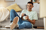 Living room, floor and man playing video game online with controller happy for virtual challenge and excited in home. Internet, user experience and person or gamer streaming sports games in apartment