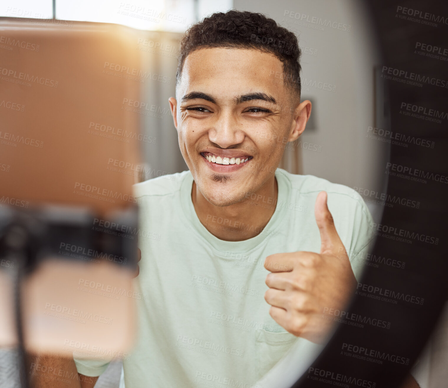 Buy stock photo Phone, thumbs up and happy man in living room with social media, review or thank you. Ring light, smile and guy influencer online with feedback hand emoji, support or live streaming, blog or podcast