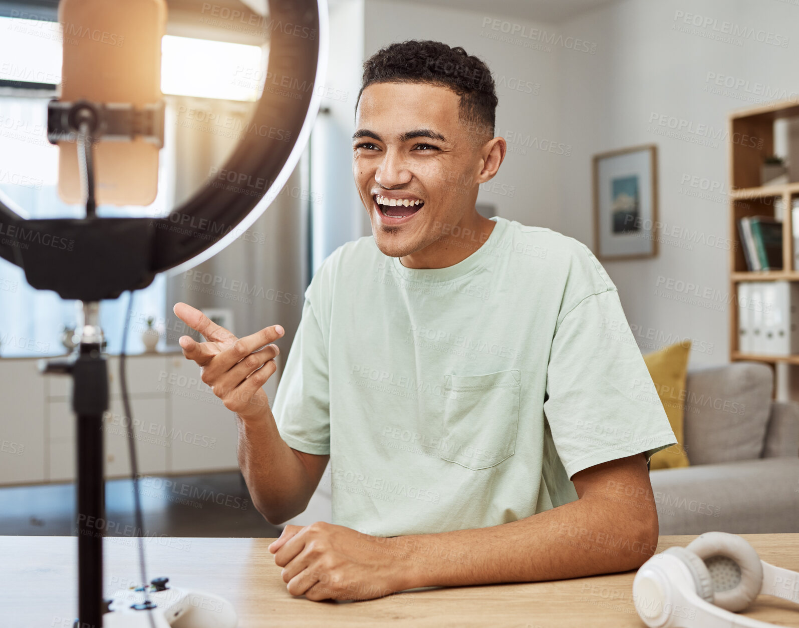 Buy stock photo Influencer, live streaming and man gamer talking on social media for connection on online vlog in a home with smile. Ring light, streamer and content creation person speaking on internet show as host