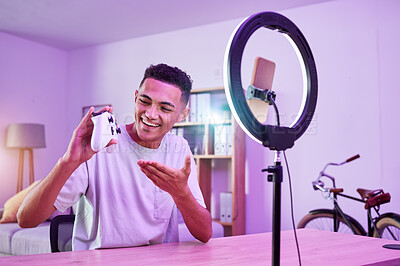 Buy stock photo Streamer, live streaming and man gamer with review of console controller on social media for connection on vlog. Ring light, influencer and content creator or person speaking on internet show as host