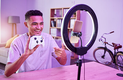 Buy stock photo Influencer, live streaming and man with review of controller or console on social media for connection on vlog. Ring light, streamer and content creator or person speaking on internet show as host