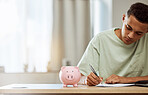 Piggy bank, finance and man with budget, writing and savings with bills, planning and future at home. Money management, growth and investment, financial strategy with notes and wealth in account 