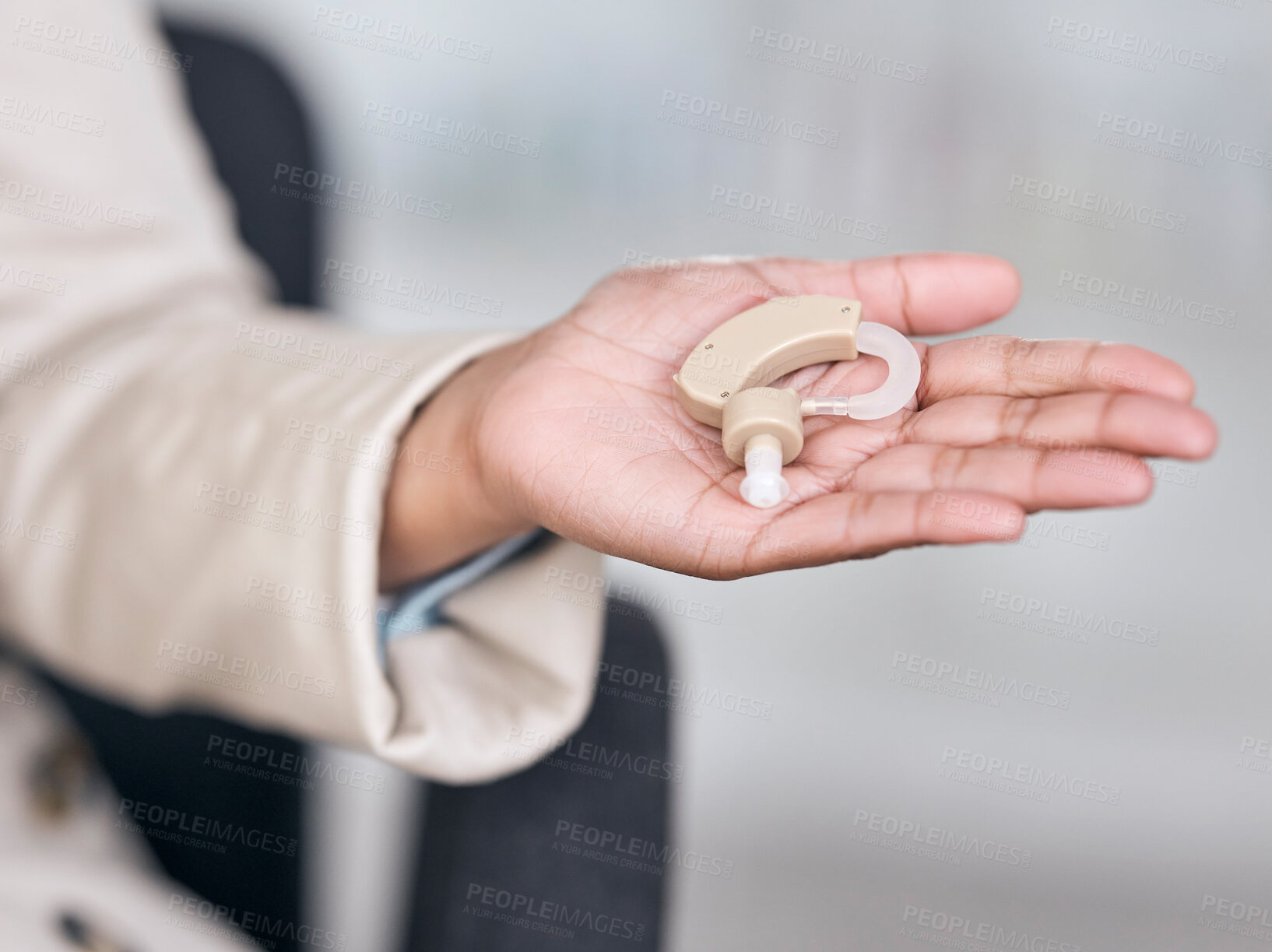 Buy stock photo Hearing aid, medical and deaf with hands of person with a disability for healthcare, technology and sound waves. Medicine, wellness and audio with closeup of cochlear implant for hearing treatment