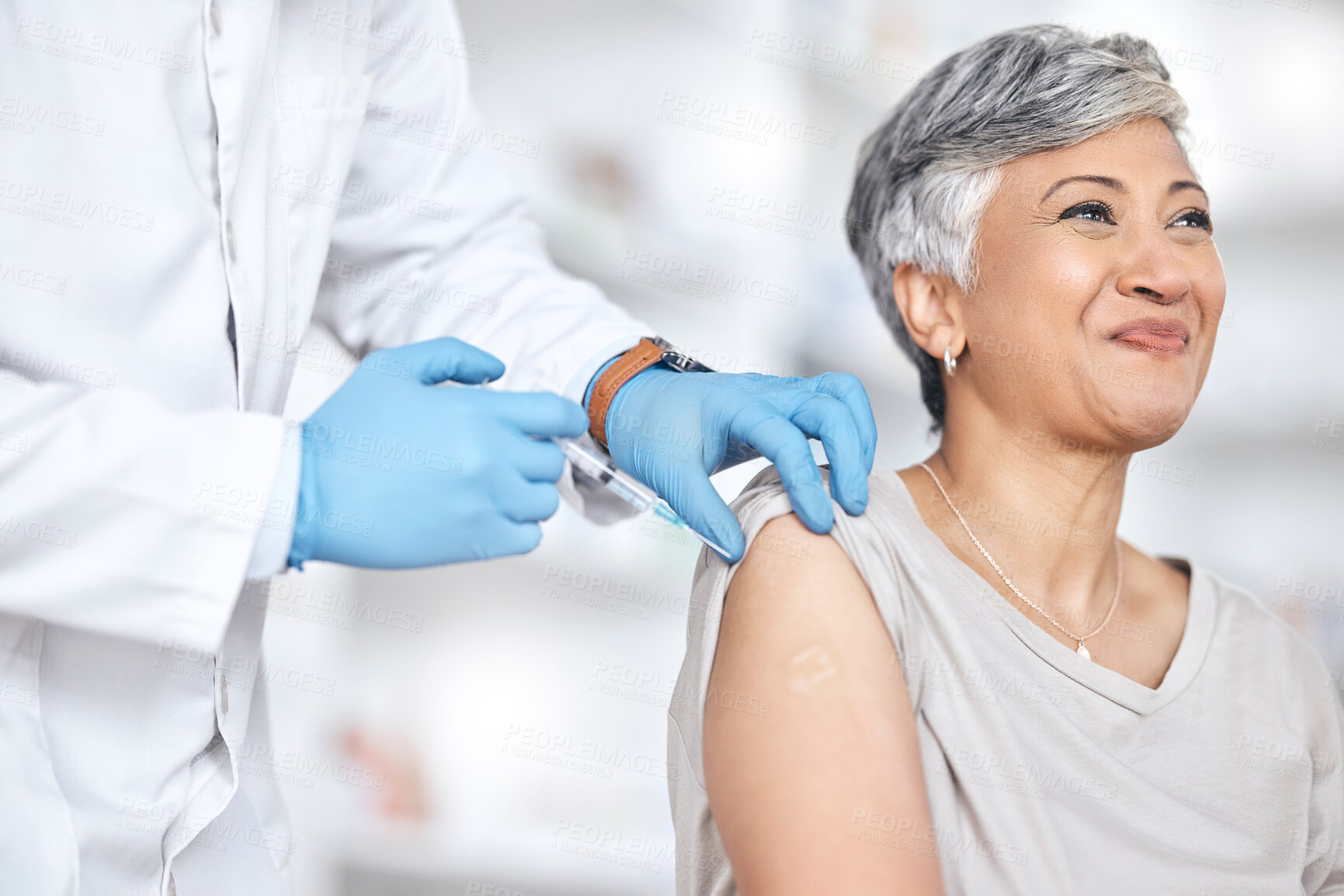 Buy stock photo Healthcare, vaccine and doctor with mature woman in consultation at hospital or clinic. Injection, syringe and happy patient with medical professional for vaccination for covid, insurance and care.