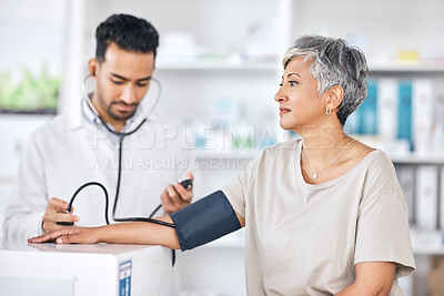 Healthcare, blood pressure and doctor with mature woman in consultation at hospital or clinic. Stethoscope, exam and patient with medical professional for check up for heart health, advice and care.