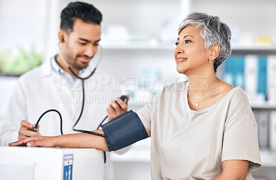 Buy stock photo Consultation, blood pressure and doctor with mature woman at hospital or clinic for healthcare. Stethoscope, exam and patient with medical professional for check up for heart health, advice and care.