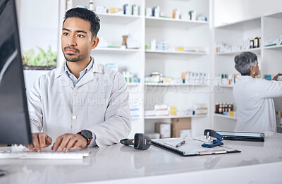 Buy stock photo Pharmacist, computer and man typing, inventory and connection with network, website information and wellness. Person, staff and employee with a pc, online reading and search internet with telehealth