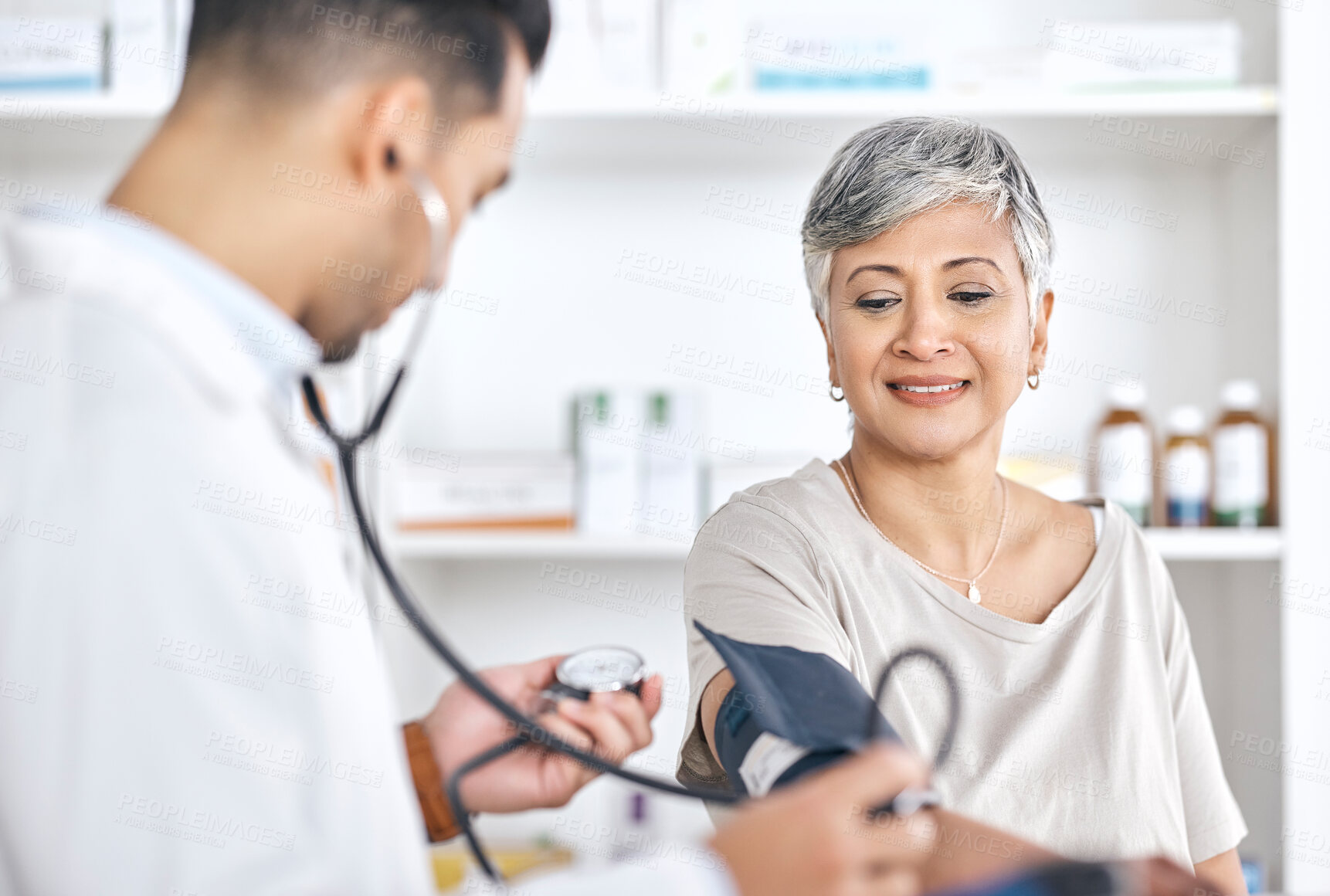 Buy stock photo Stethoscope, blood pressure and doctor with mature woman in consultation at hospital or clinic. Healthcare, exam and patient with medical professional for check up for heart health, advice and care.