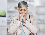 Sick, sneeze and mature woman in pharmacy, allergy or cold medicine in pharmaceutical health shop. Blowing nose, tissue and person in drug store for covid medication, medical asthma treatment or flu