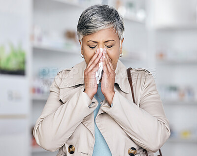 Buy stock photo Sick, sneeze and mature woman in pharmacy, allergy or cold medicine in pharmaceutical health shop. Blowing nose, tissue and person in drug store for covid medication, medical asthma treatment or flu