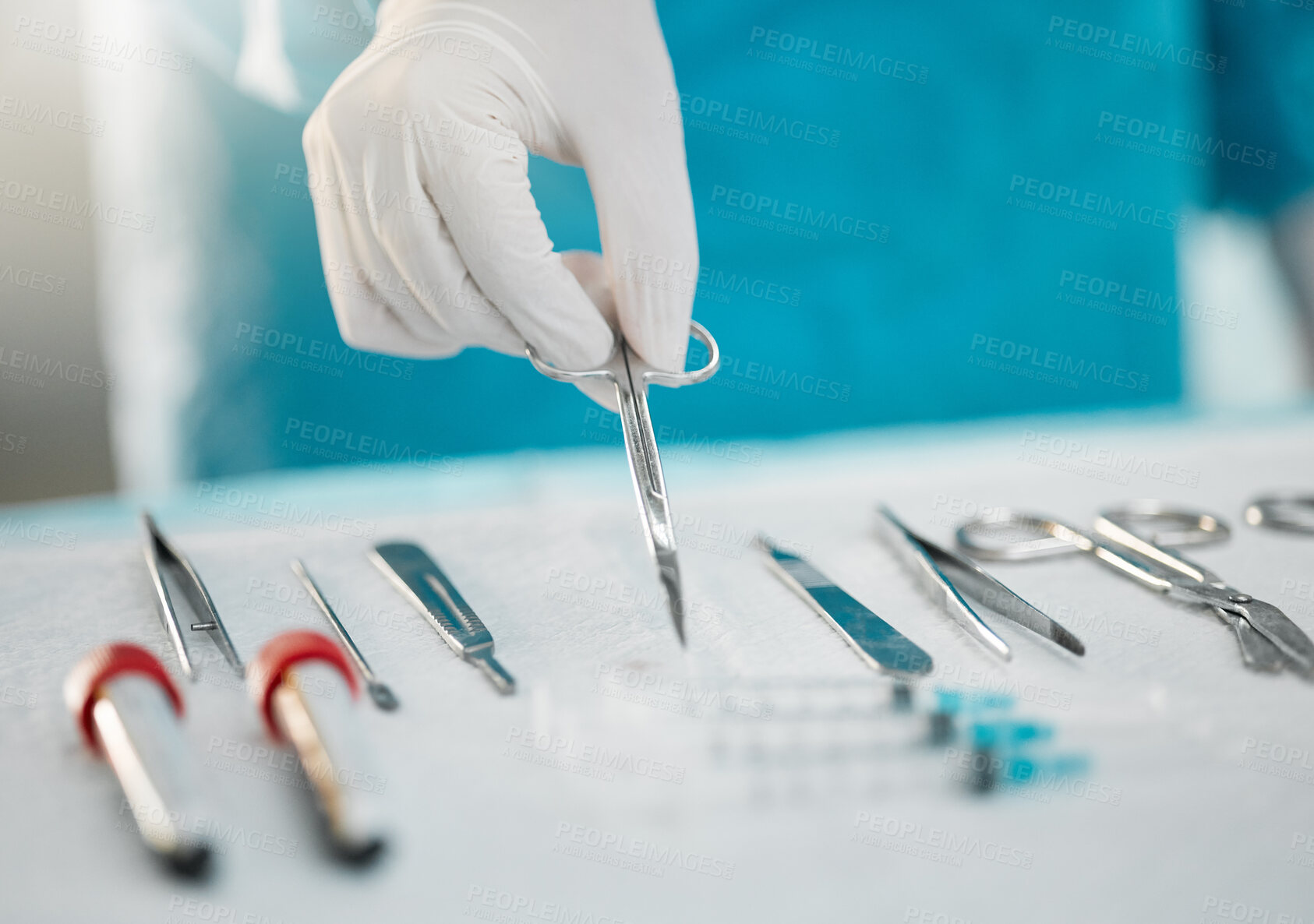 Buy stock photo Surgery equipment, table and hands with scissors for a medical procedure in theater. Closeup, hospital and a doctor or surgeon with gear for healthcare, operation or an emergency service in nursing