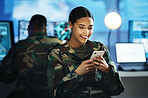 Phone, military and woman soldier in the control room in uniform for war or battle networking. Happy, smile and young female army warrior typing a message on internet with cellphone for surveillance.