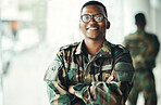 Confident soldier portrait, smile and arms crossed in army building, pride and professional hero service. Military career, security and courage, black man in camouflage uniform at government agency.