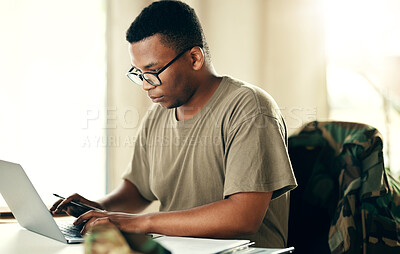 Buy stock photo Laptop, serious soldier and black man typing at table in home, planning and remote work. Computer, veteran on internet and technology on desk for freelancer in army, search and reading military email