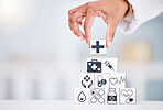 Hands, healthcare and a building blocks tower in a hospital with a doctor closeup for health insurance. Medicine, icon and symbol with a medicine professional in a clinic for cardiology or treatment