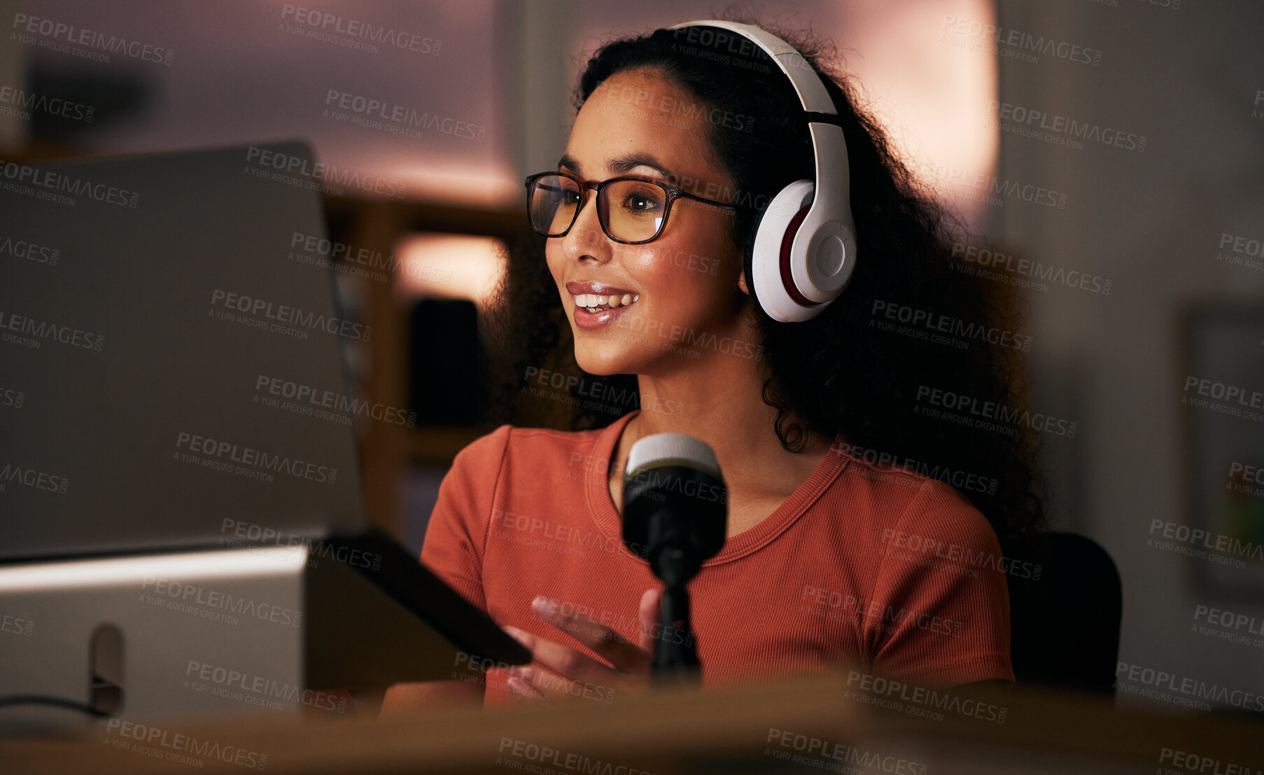 Buy stock photo Woman, headphones and laptop with radio DJ or podcast, public relations journalist and live broadcast at night. Mic, talk show and communication for social media streamer and content creation