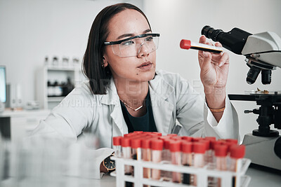 Buy stock photo Scientist, woman and blood test, microscope or laboratory research for DNA, virus analysis or medical study. Professional science or asian person in biotechnology, glasses or check red liquid in tube