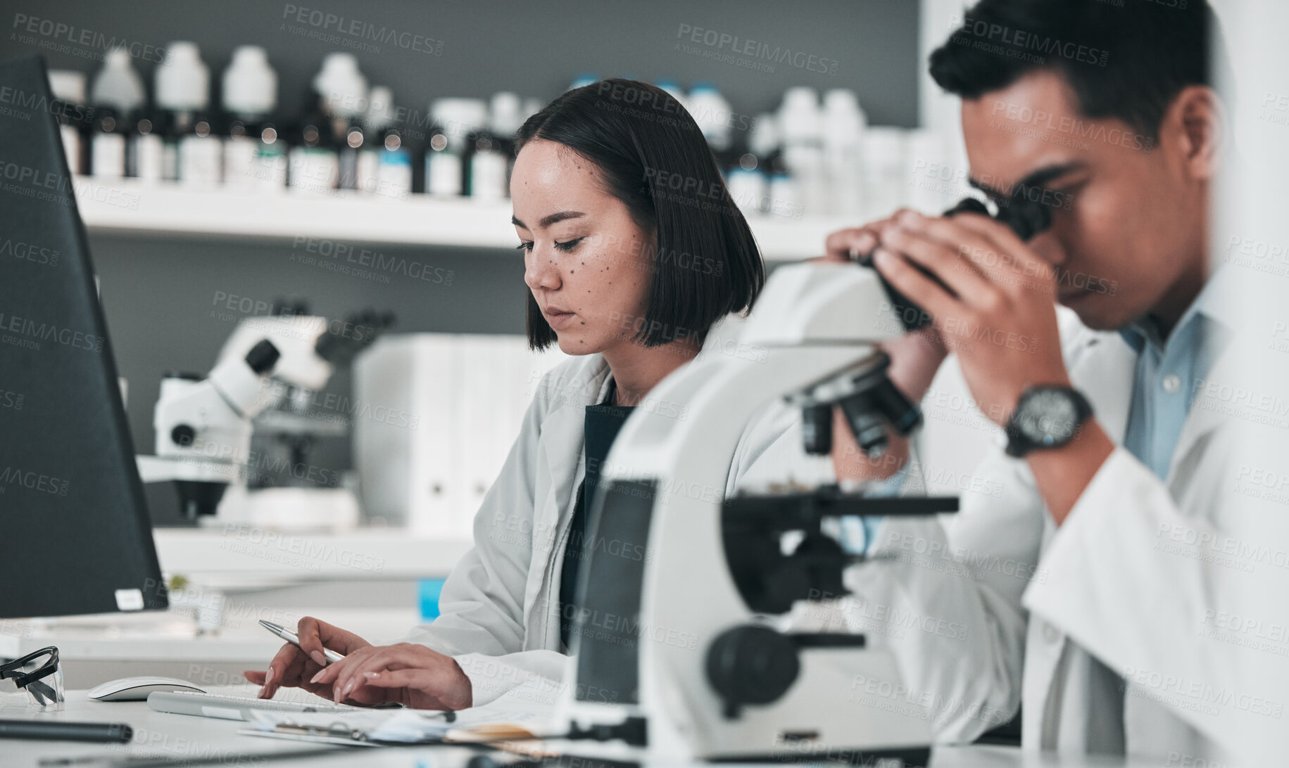 Buy stock photo Science, team in research and man with microscope in laboratory, data for drugs or medical innovation. Healthcare, biotech lab analytics and medicine, scientist collaboration in pharmaceutical study.