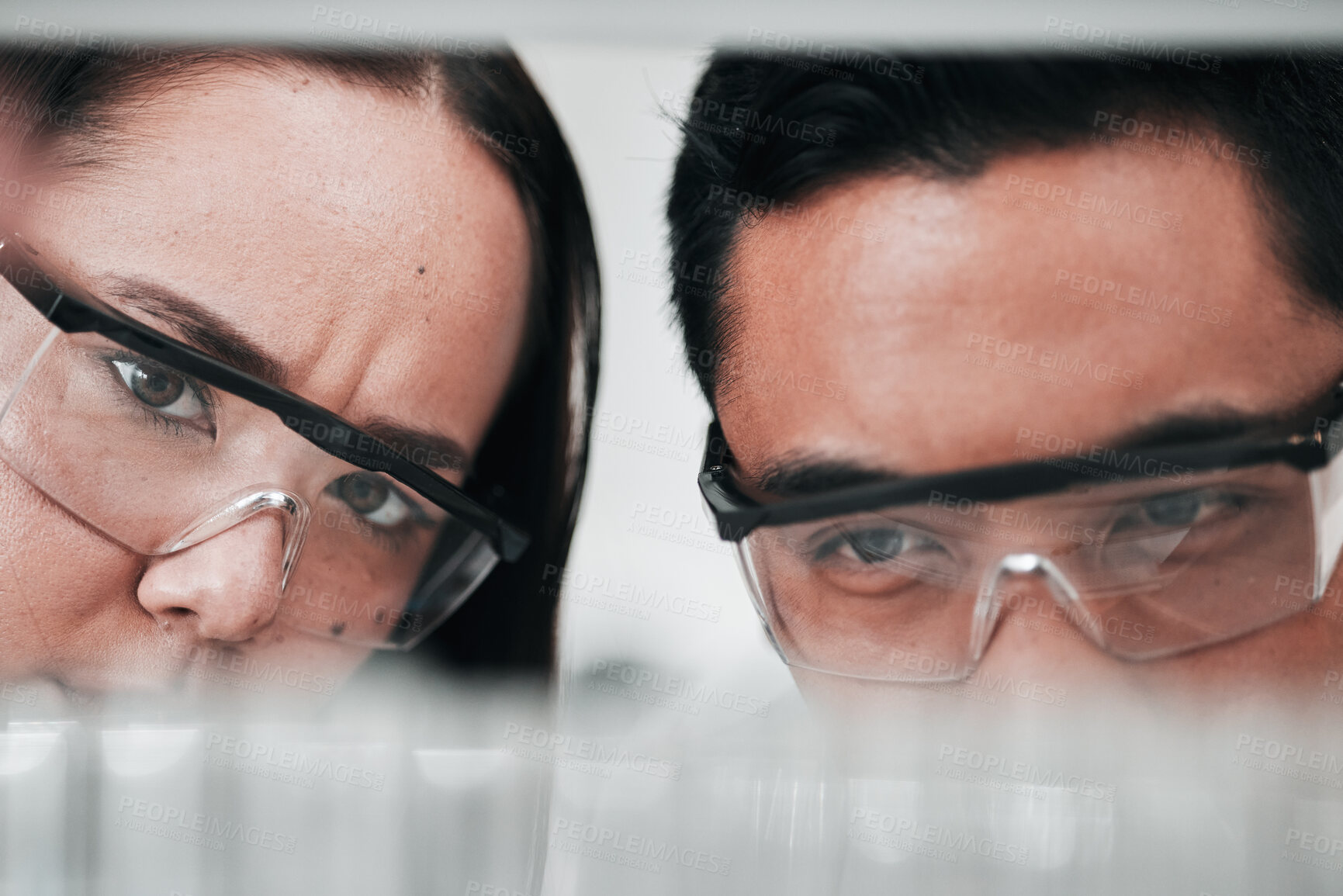 Buy stock photo Science, woman and man looking at test tube in laboratory, research in vaccine results and medical innovation. Healthcare, biotech lab analytics and medicine, scientist team in pharmaceutical study.