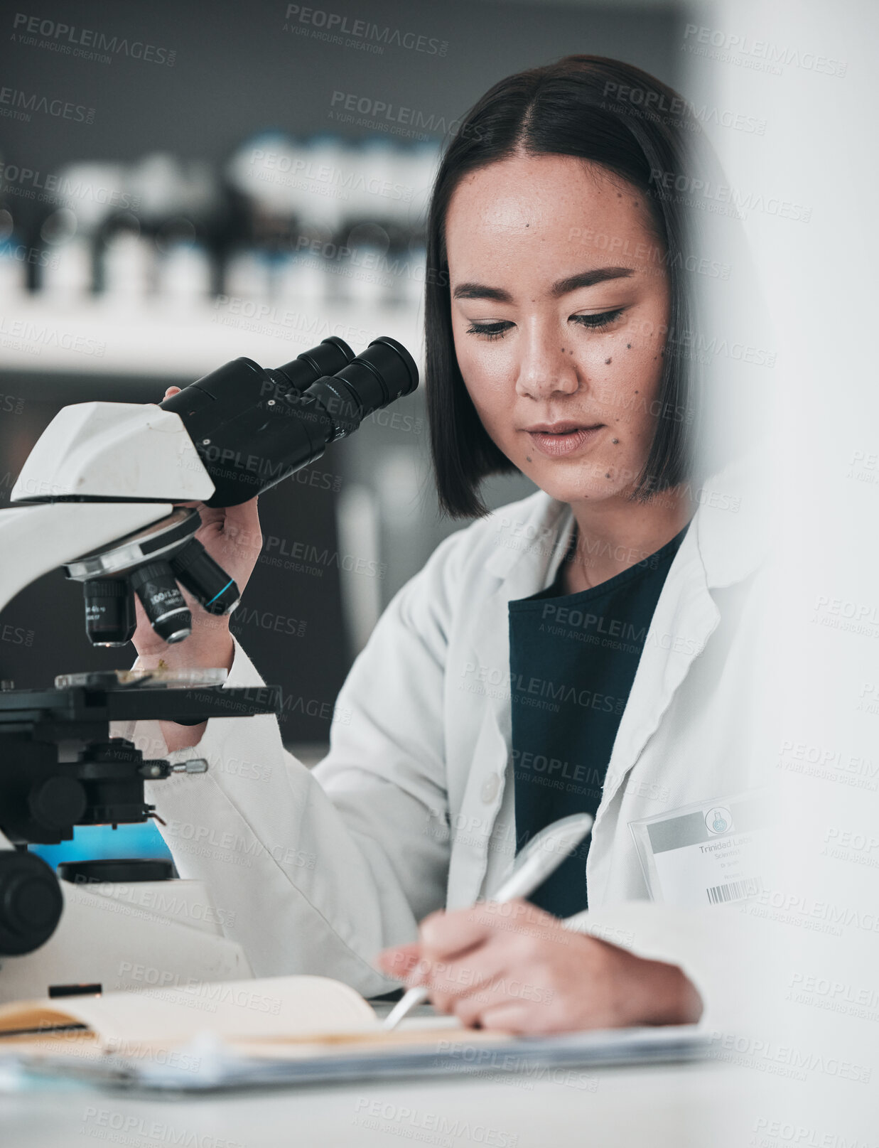 Buy stock photo Microscope, asian woman and writing in laboratory for science development, planning analysis and research notes. Scientist, biotechnology and lens to review investigation, test report and dna results