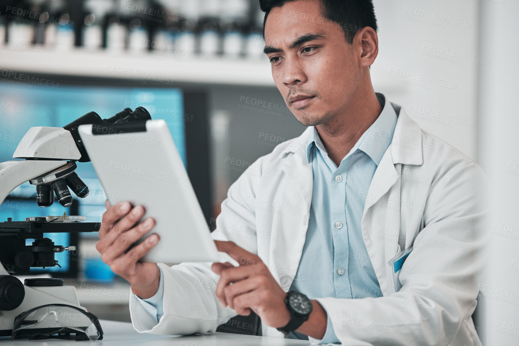 Buy stock photo Scientist, man and tablet for laboratory research, data analysis and reading microscope results or test report. Doctor or medical expert on digital technology, science software and healthcare review