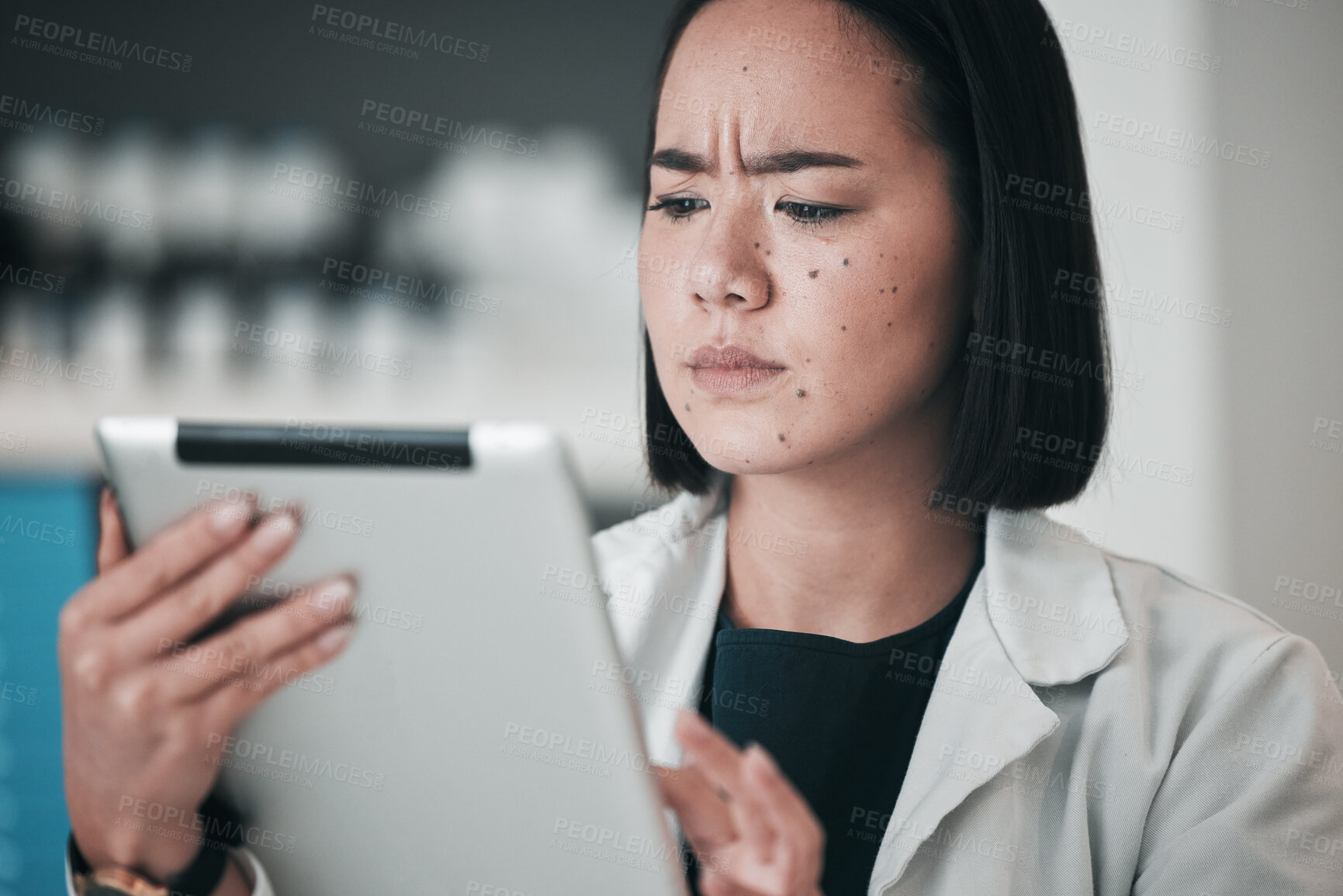 Buy stock photo Tablet, pharmacy and confused Asian woman in laboratory for website, wellness app and telehealth. Healthcare, pharmaceutical and worker on digital tech for medical service, medicine and research