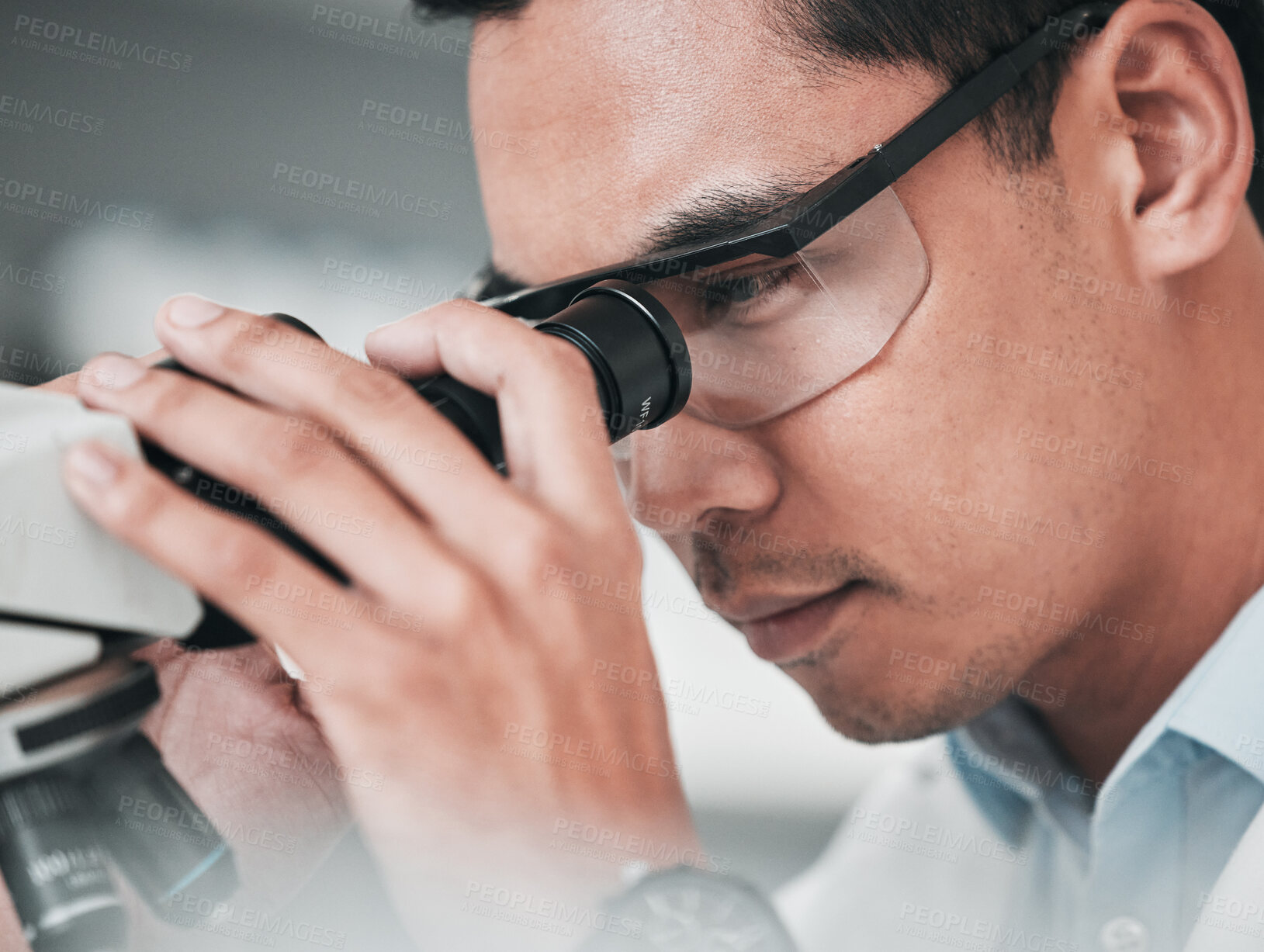 Buy stock photo Microscope, face and man in medical laboratory for research, dna analysis or development of science innovation. Asian scientist, biotechnology or check lens for investigation, particles or assessment