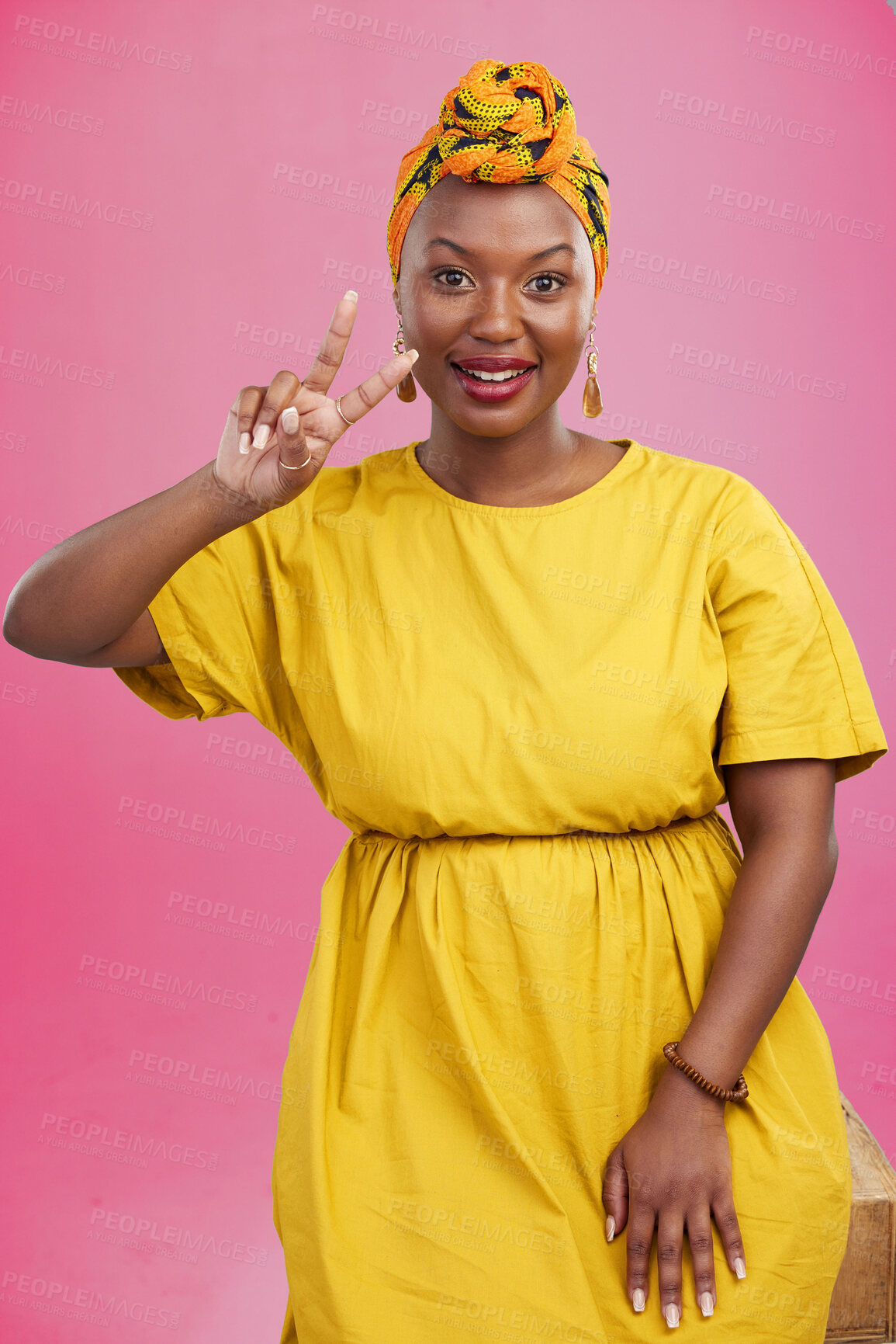 Buy stock photo Black woman, peace sign and smile in studio portrait with fashion, emoji or hand icon by pink background. African girl, yellow dress and happy with v, vote and opinion for success with trendy style 