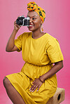 Camera, studio and happy black woman shooting photo, picture or photography of creative fashion design. Creativity photoshoot, talent artist and African production photographer on pink background