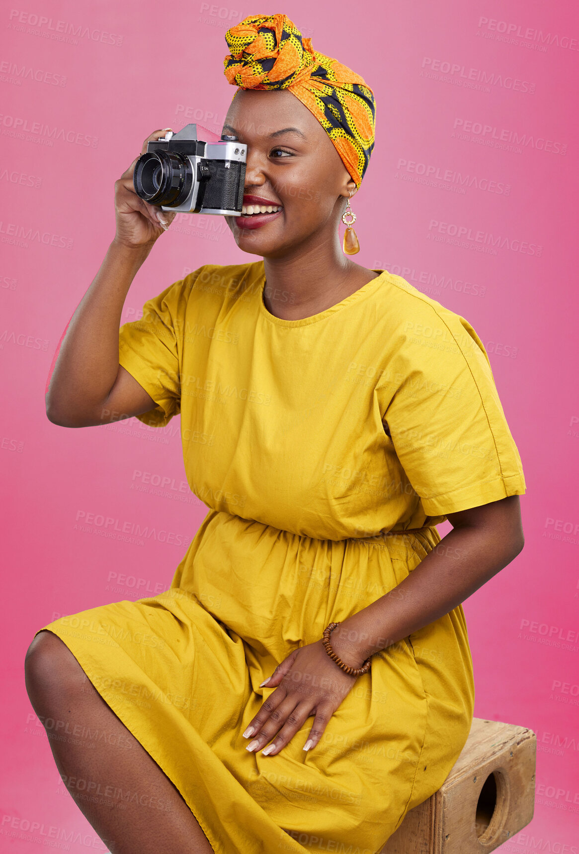 Buy stock photo Camera, studio and happy black woman shooting photo, picture or photography of creative fashion design. Creativity photoshoot, talent artist and African production photographer on pink background