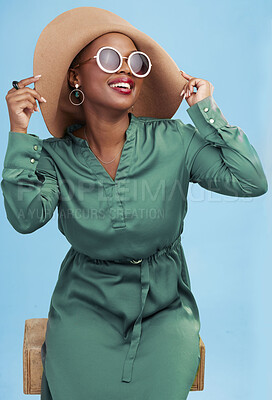 Buy stock photo Fashion, travel and black woman with sunglasses for cool style summer isolated in a studio blue background. African, hat and young person relax with clothes for glamour or luxury accessories