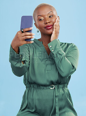 Buy stock photo Smile, selfie and happy black woman for mobile app video call isolated in studio blue background with prize. Connection, calm and person, content creator or influencer live streaming on social media