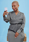Smile, selfie and black woman beauty on app or video call isolated in studio blue background with style. Connection, African and influencer person or content creator live streaming on social media