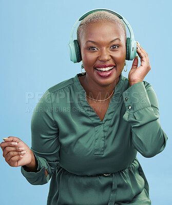 Buy stock photo Dance music, portrait or happy black woman have fun, smile and listening to podcast, radio network or song. Happiness, studio or African dancer streaming audio, headphones or sound on blue background