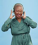 Happy black woman, headphones and dancing to music, audio track or sound against a studio background. African female person smile enjoying podcast, streaming or listening to entertainment on headset