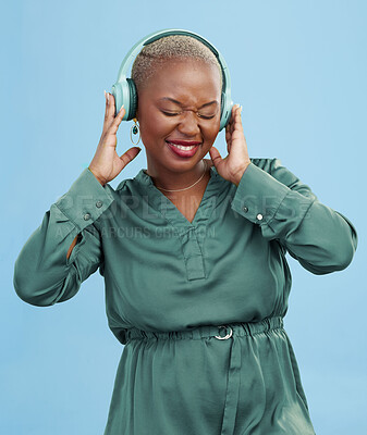 Buy stock photo Happy black woman, headphones and dancing to music, audio track or sound against a studio background. African female person smile enjoying podcast, streaming or listening to entertainment on headset