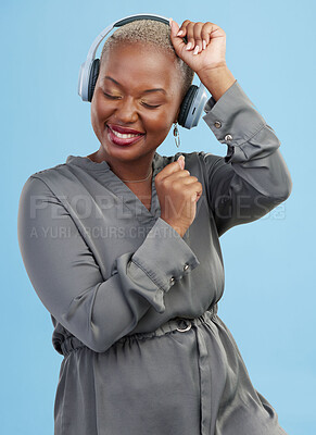 Buy stock photo Headphones, music and black woman on blue background dance for happiness, relax and chill. Happiness, technology and happy African person streaming audio, listening to radio and song in studio