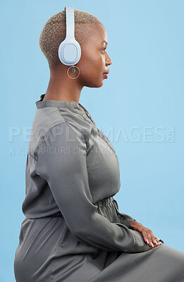 Buy stock photo Headphones, music and profile of black woman on blue background for wellness podcast, relax and chill. Profile, technology and African person streaming audio, listening to radio and song in studio