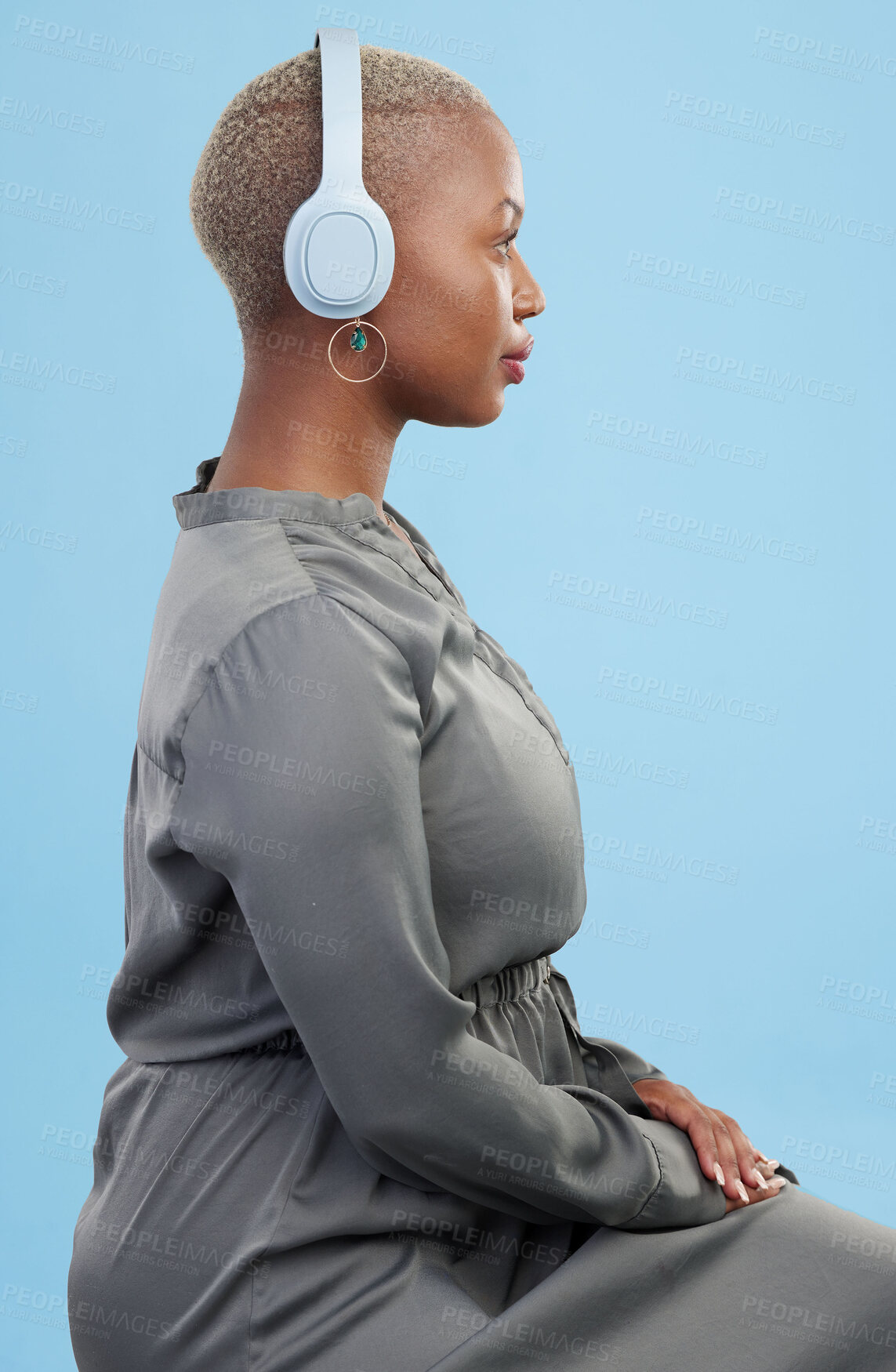 Buy stock photo Headphones, music and profile of black woman on blue background for wellness podcast, relax and chill. Profile, technology and African person streaming audio, listening to radio and song in studio