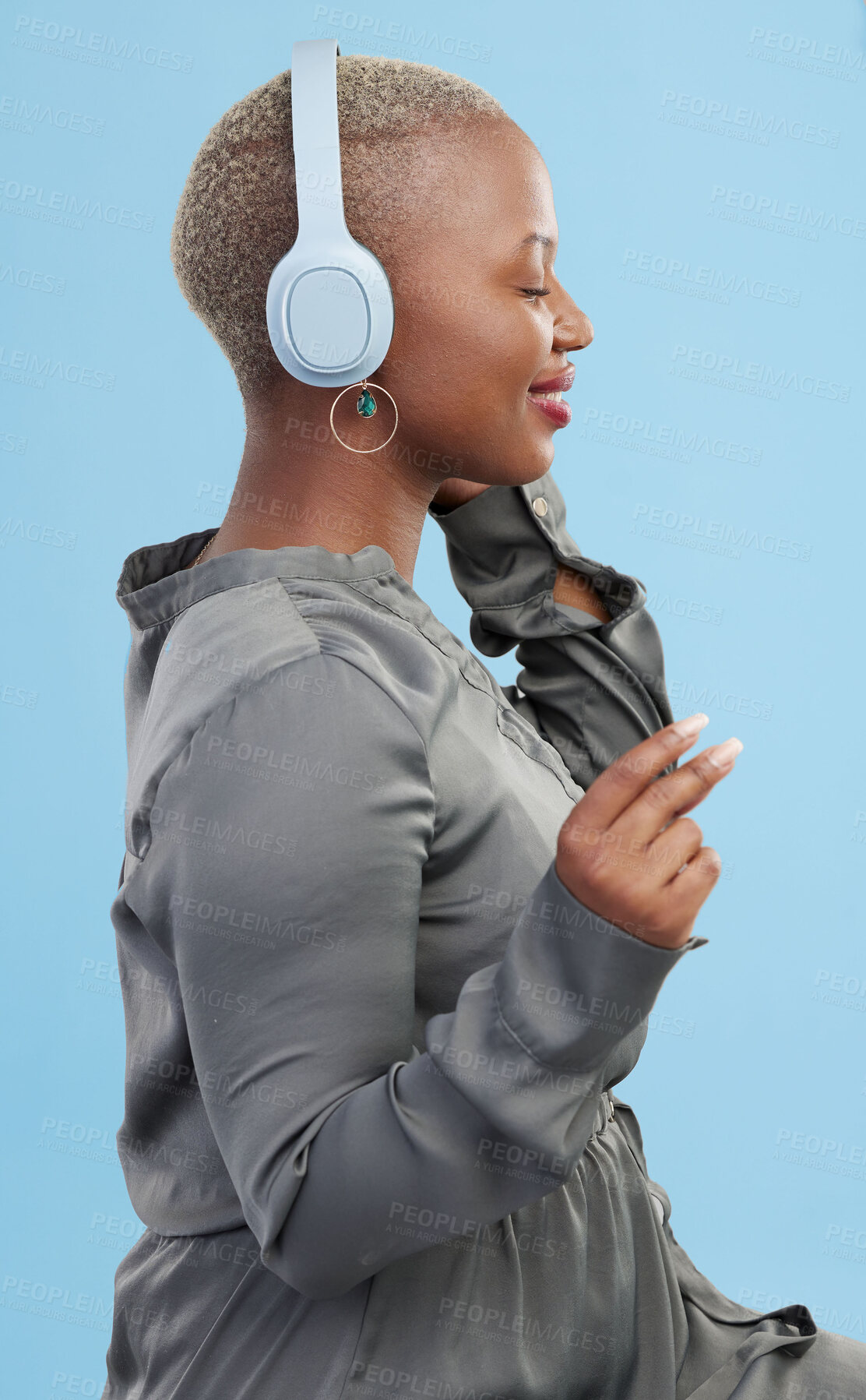 Buy stock photo Black woman, headphones and music, profile and technology with audio streaming isolated on blue background. Listening to radio, wireless tech for podcast and subscription with peace in studio