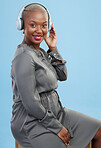 Black woman, headphones and music in studio portrait, smile and listening to radio by blue background. African girl, audio tech and streaming subscription service with sound, hearing and relax