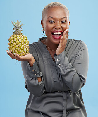 Buy stock photo Portrait, wow and black woman pineapple in studio for detox, lose weight or diet nutrition on blue background. Fruit, face and African lady nutritionist show vegan, lifestyle or organic diet choice