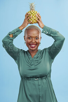 Buy stock photo Portrait, happy and black woman pineapple in studio for detox, lose weight or diet nutrition on blue background. Fruit, face and African lady nutritionist show vegan, lifestyle or organic diet choice